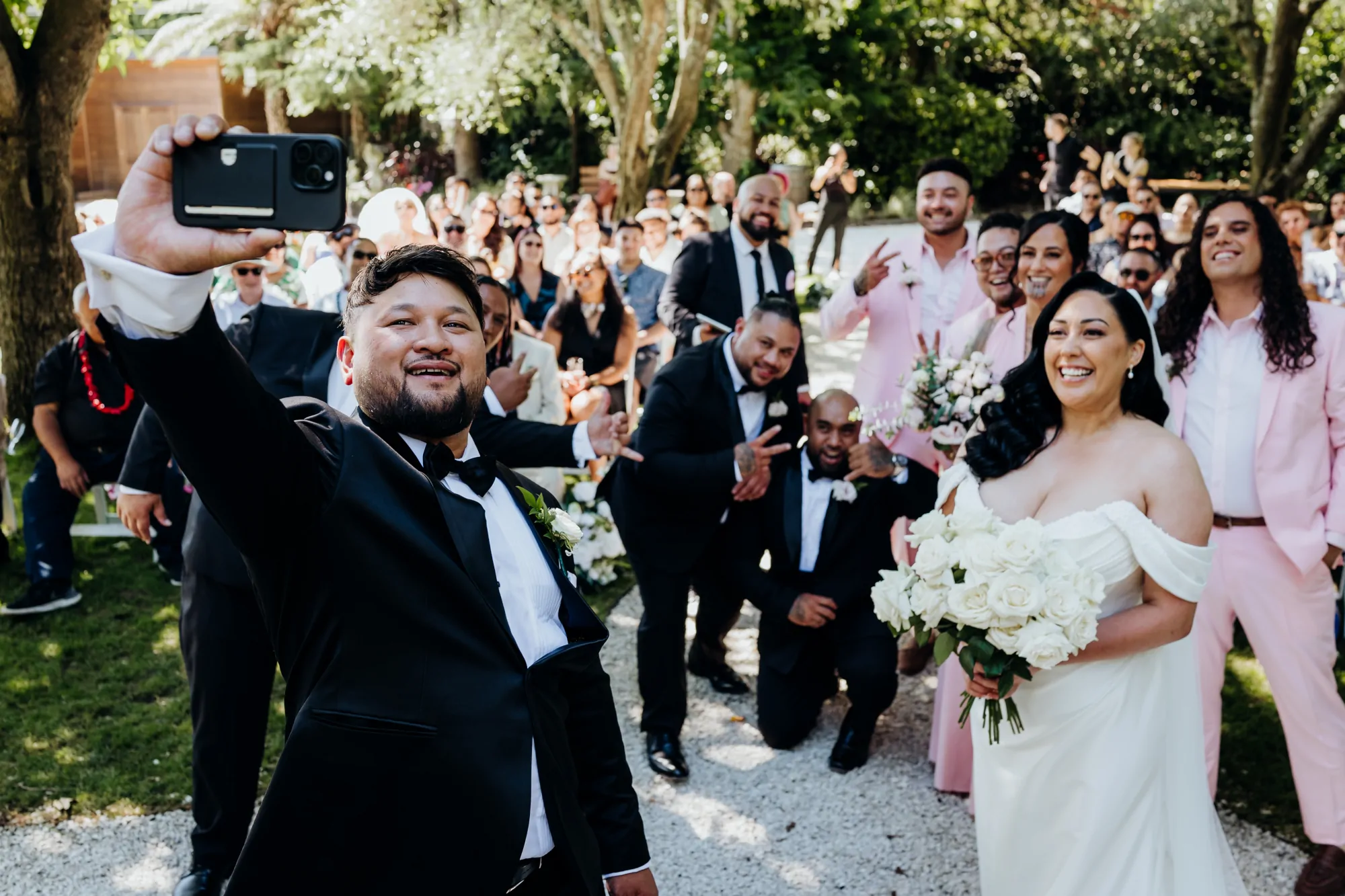 A joyful wedding party celebrating outdoors