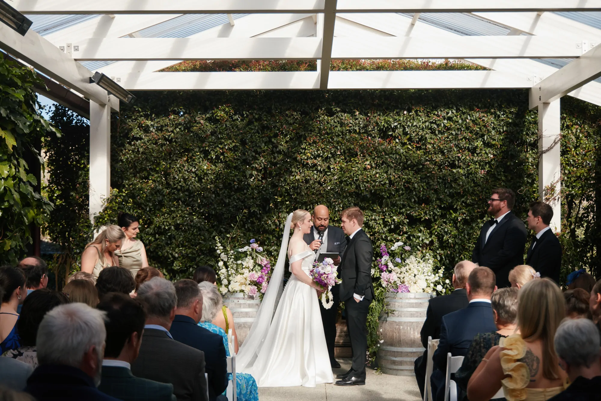 Nate Dunn officiating a wedding ceremony at Mudbrick Vineyard and Restaurant in Waiheke Island